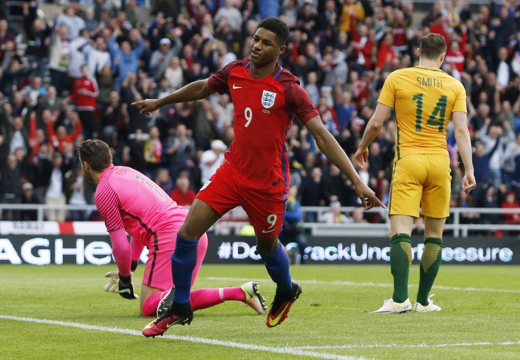 Marcus Rashford celebrating debut England goal wearing red number 9 jersey vs Australia goalkeeper Wallpaper