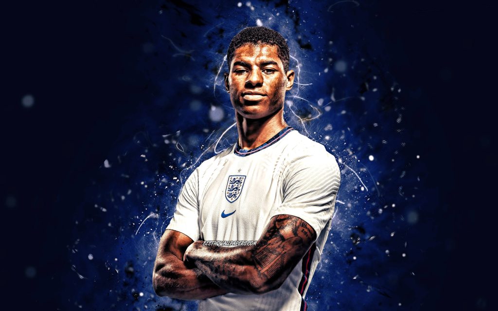 Marcus Rashford in white England jersey with blue energy effects on dark digital wallpaper background