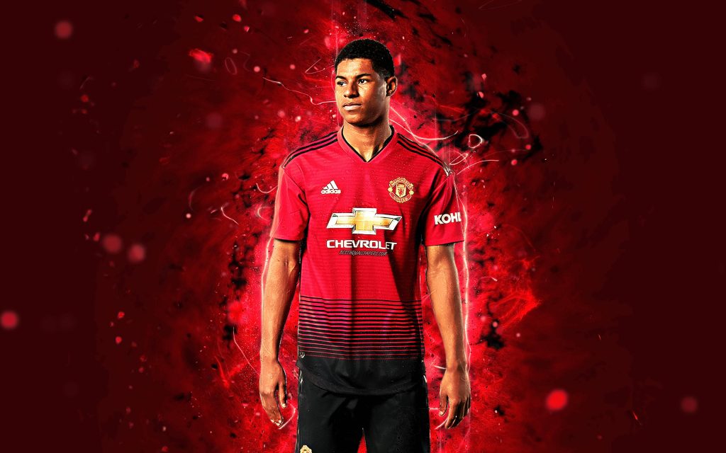 Marcus Rashford in red jersey intense pose fiery crimson background Manchester United wallpaper