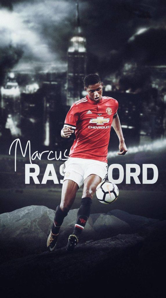 Marcus Rashford dribbling soccer ball in classic red Manchester United kit urban wallpaper