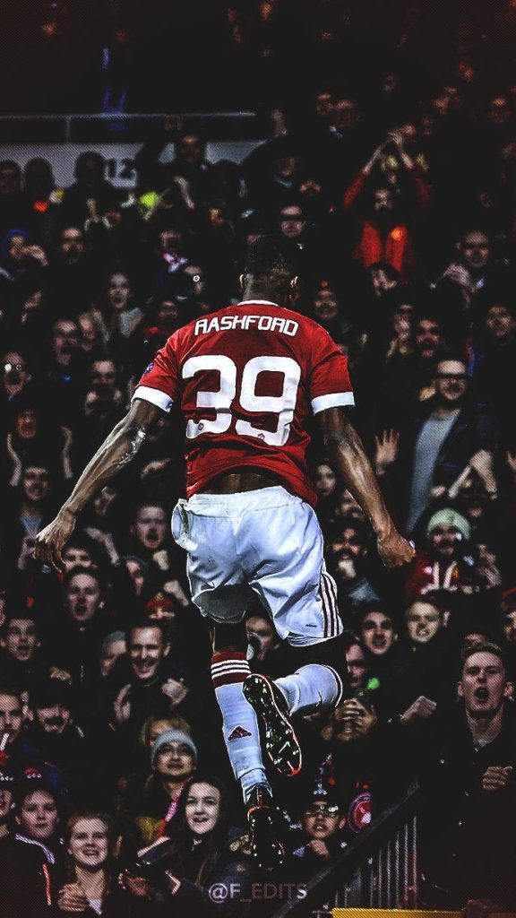 Marcus Rashford mid-jump Manchester United debut season 39 dramatic wallpaper background fans