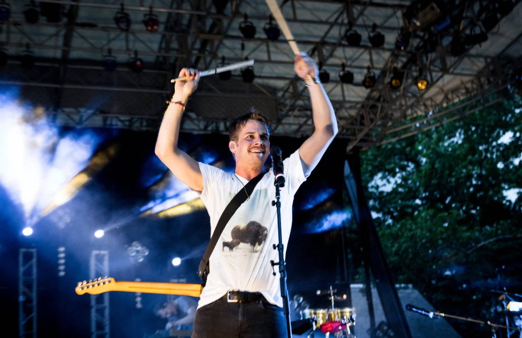 Mark Foster of Foster the People performing live on stage with drumsticks upbeat wallpaper