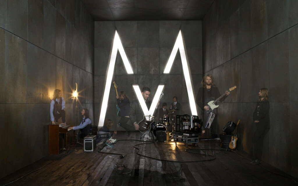Maroon 5 in modern recording studio with glowing M logo capturing creative energy wallpaper