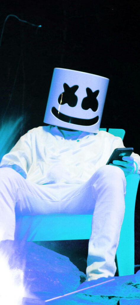 Neon Dreams: Marshmello's HD iPhone Background captures the iconic DJ in a white helmet, jacket, and pants, chilling on a vibrant blue throne. Wallpaper