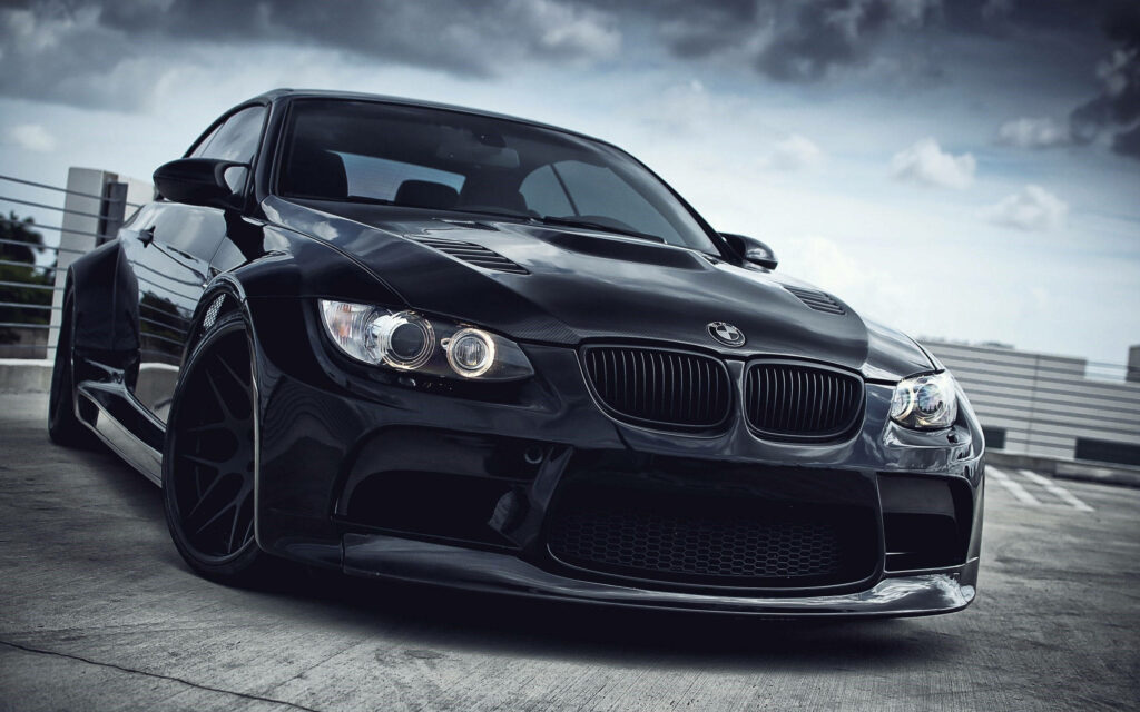 Under the Gloom: A Striking BMW M3 Sedan in an Eerie Ambience Wallpaper