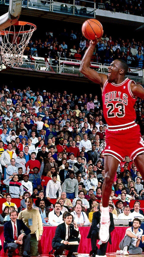 Astonishing Snapshot of the Iconic Michael Jordan Nailing an Effortless Dunk: Marvelous Basketball Genius in Action Wallpaper