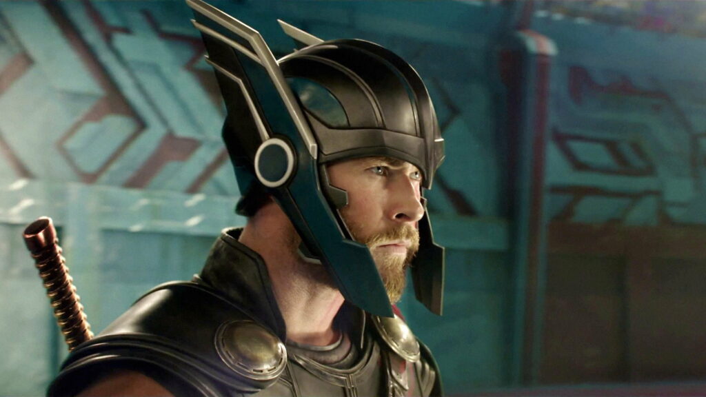 Chris Hemsworth as Thor in winged gladiator helmet profile with vibrant teal background wallpaper