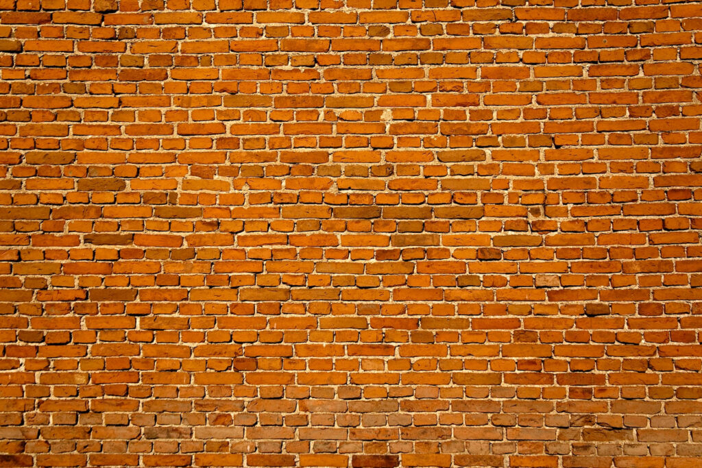 Realistic rustic brick wall wallpaper with warm terracotta clay bricks and textured running bond pattern