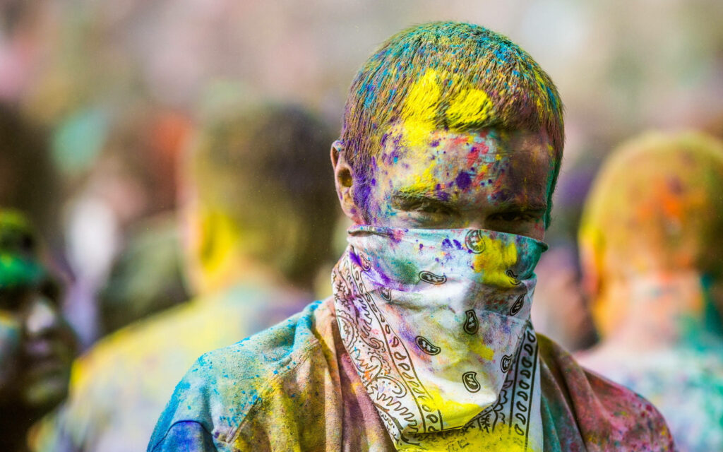 Colorful Celebration: Masked Man in Happily Holi HD Wallpaper