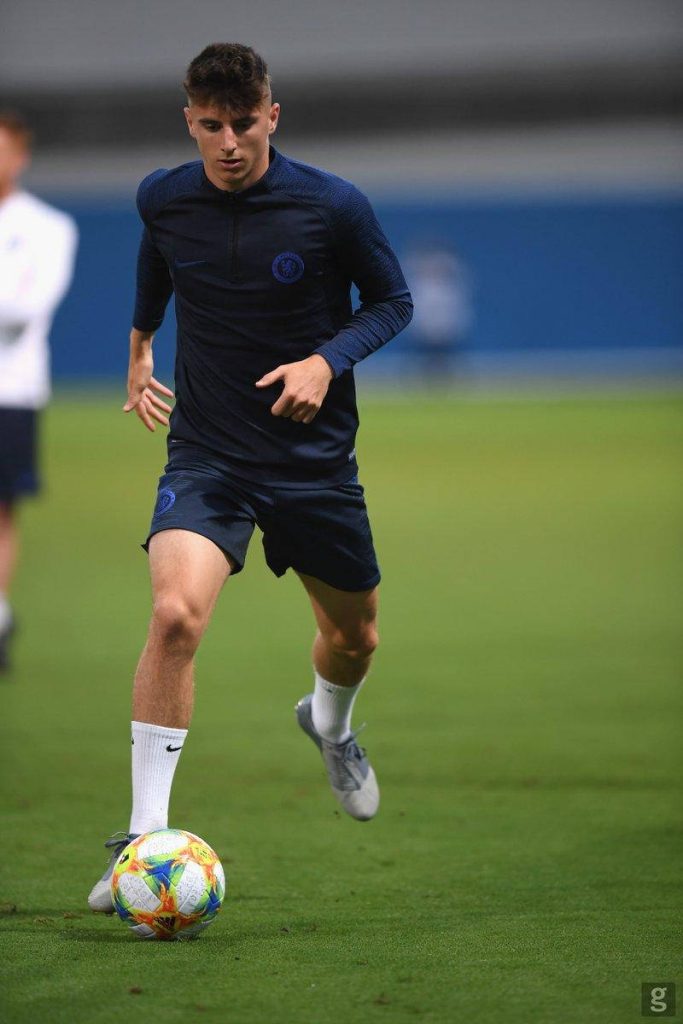 Mason Mount in dark blue Chelsea training kit dribbling ball on grass pitch action shot wallpaper