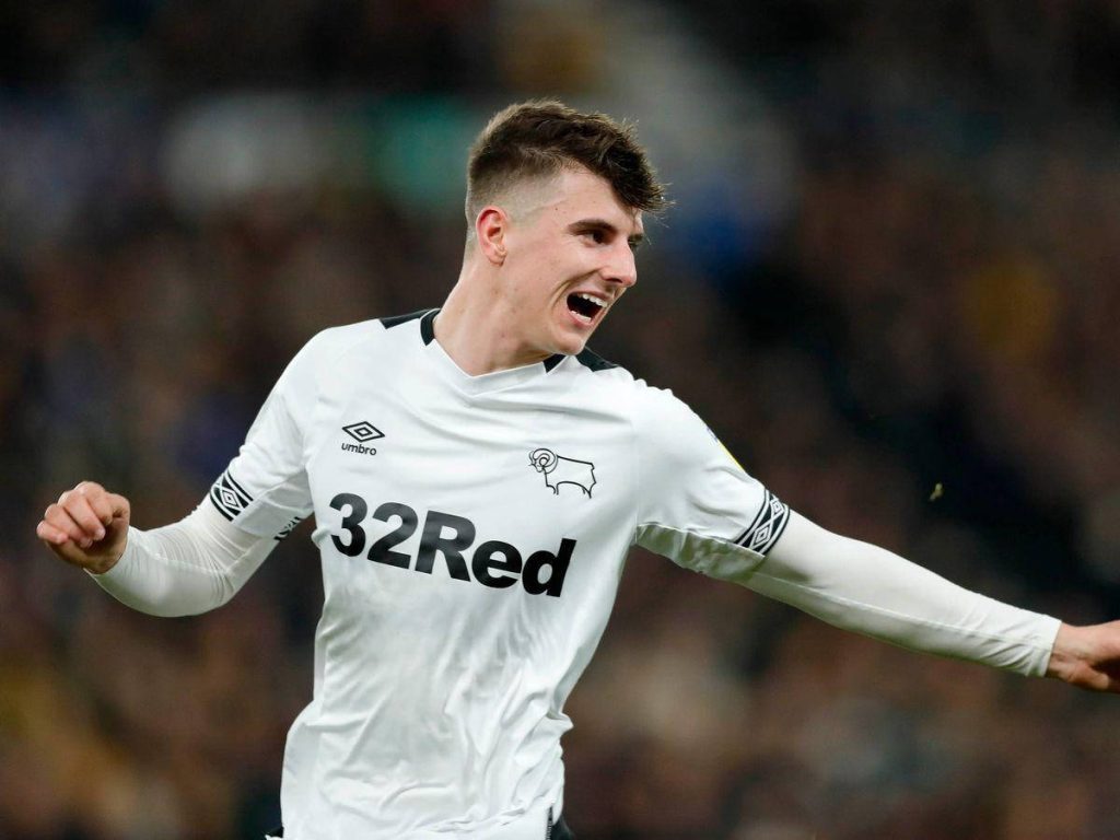 Mason Mount celebrating a goal in white Derby County kit with blurred stadium background Wallpaper