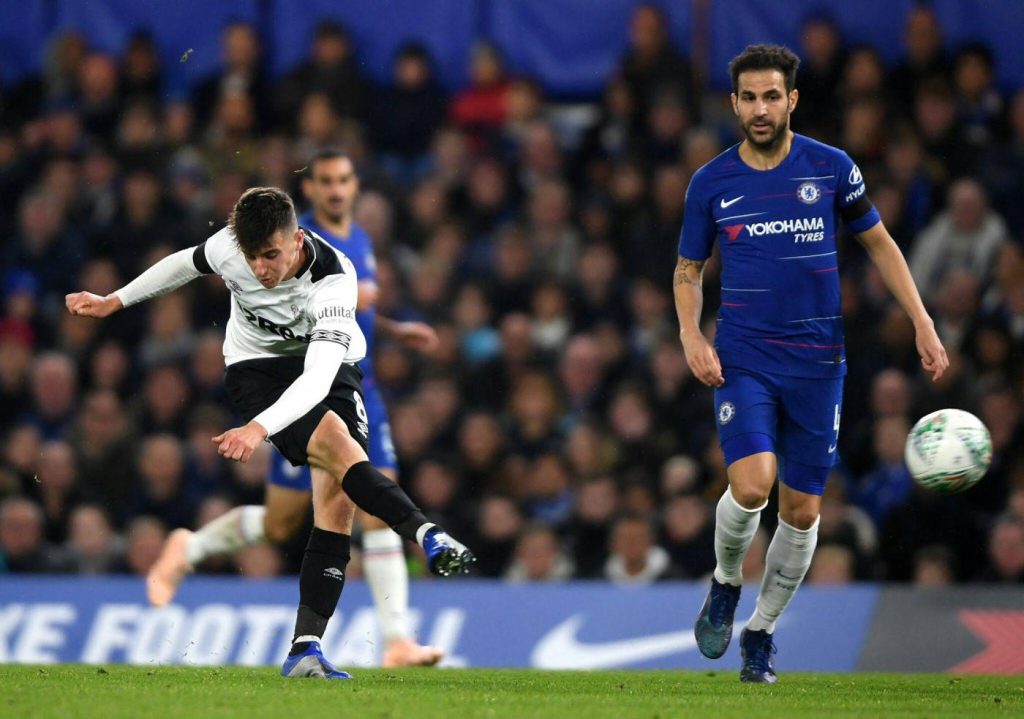 Mason Mount striking ball for Derby County vs Chelsea with Cesc Fàbregas watching intense match Wallpaper
