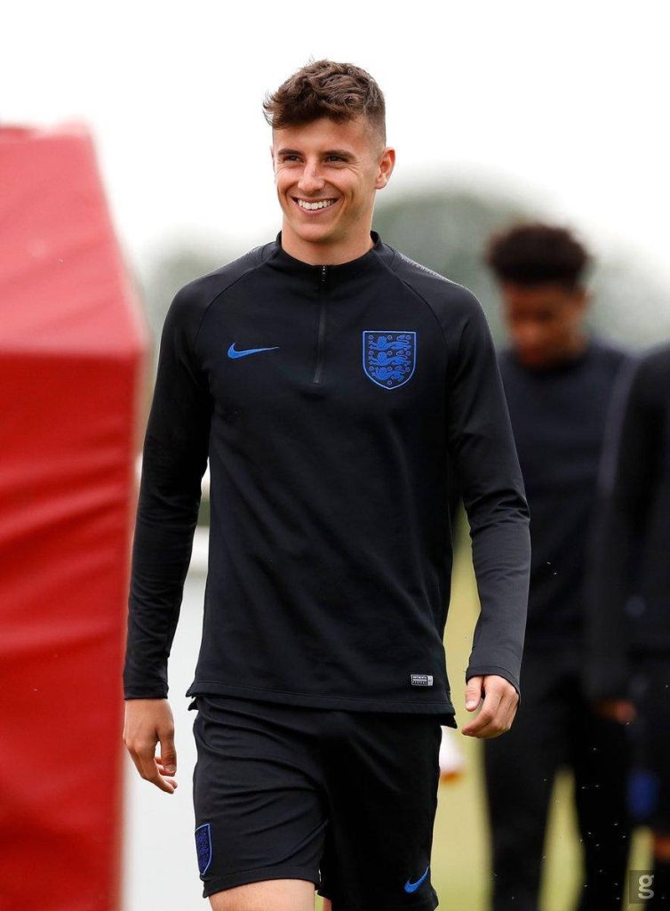 Mason Mount smiling in England black training kit with Three Lions crest football wallpaper