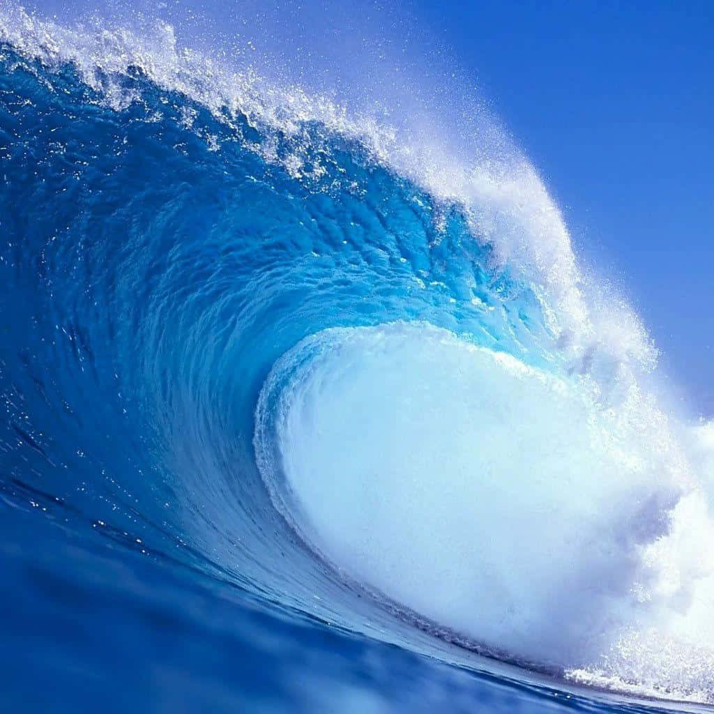 Massive turquoise ocean wave crashing with bright sea foam vibrant nature desktop wallpaper