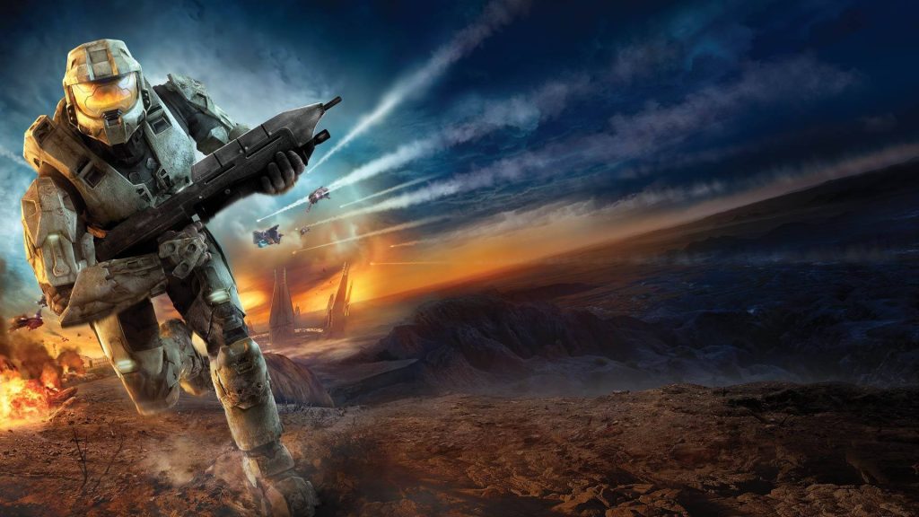 Master Chief in Halo Infinite CGI wallpaper with assault rifle against fiery sunset battlefield