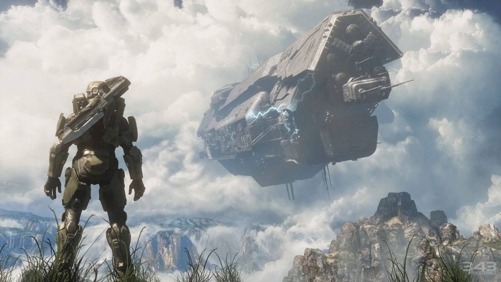 Master Chief overlooking massive UNSC spaceship with dramatic clouds and mountains Halo Infinite Wallpaper