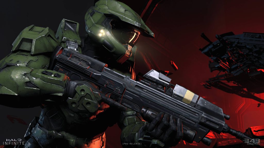 Master Chief in weathered green armor with MA40 rifle on dramatic red Halo Infinite wallpaper