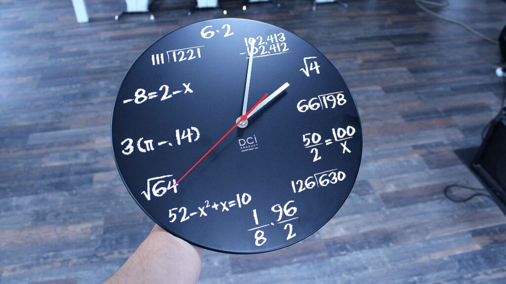 Black math clock wallpaper with white equations marking hours modern educational design