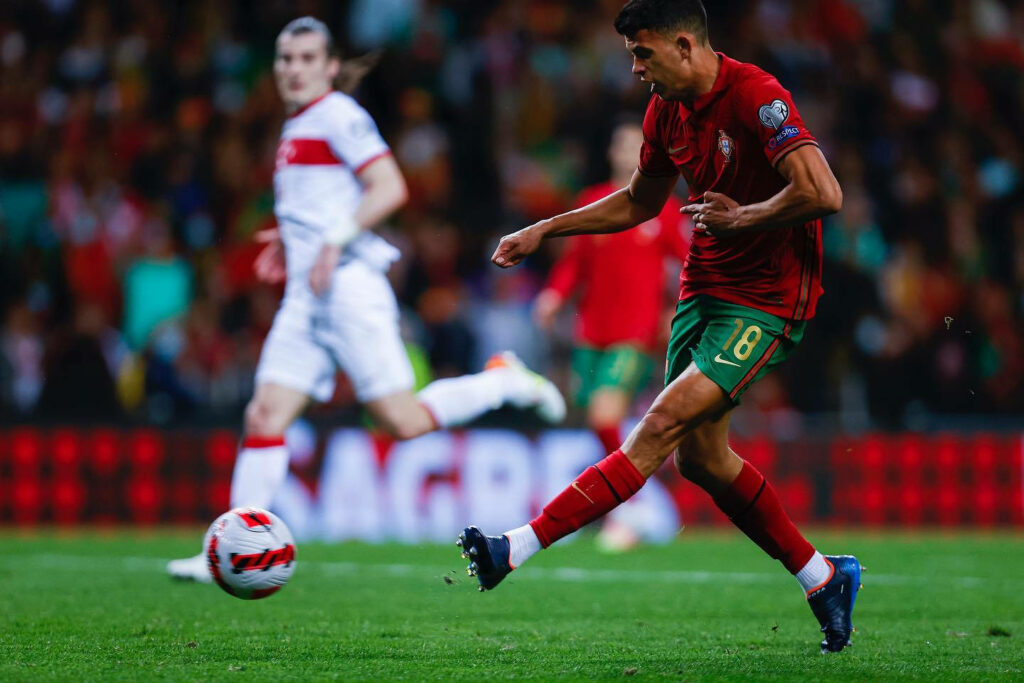 The Determined Matheus Nunes Chases Victory on the Field as an Opponent Lingers in the Background Wallpaper