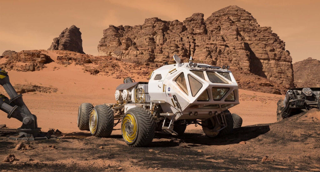 Matt Damon as astronaut Mark Watney with Mars rover on rugged red Martian landscape wallpaper