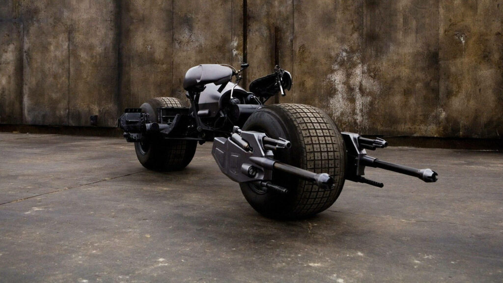 The Dark Knight Emerges: A Striking Display of the Batmobile Motorcycle's Sleek Design in Broad Daylight Wallpaper