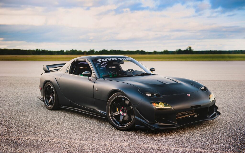 Sleek Matte Black Mazda RX-7: Tuning Mods in Scenic Landscape Wallpaper