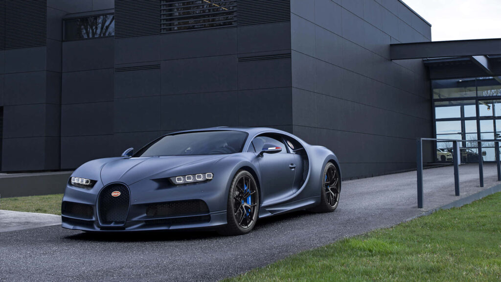 Matte blue Bugatti Chiron parked by modern building showing sleek curves and luxury design Wallpaper