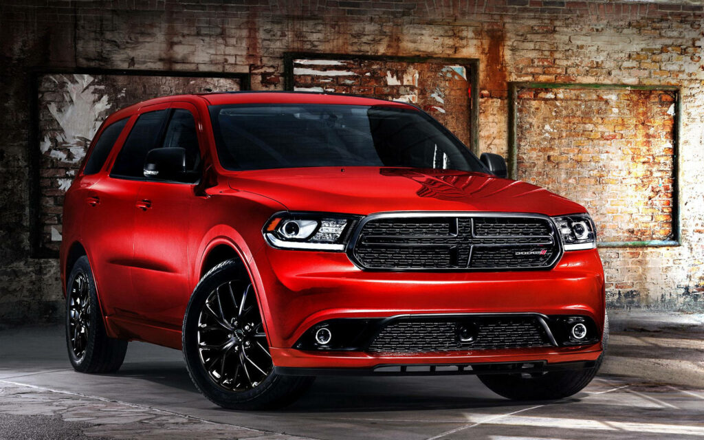 Matte red Durango in industrial setting showcasing sleek design high performance wallpaper background