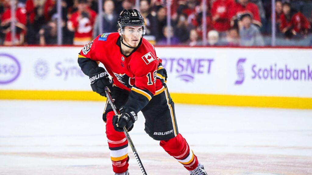 Matthew Tkachuk Calgary Flames in red black uniform action ice hockey game dynamic wallpaper