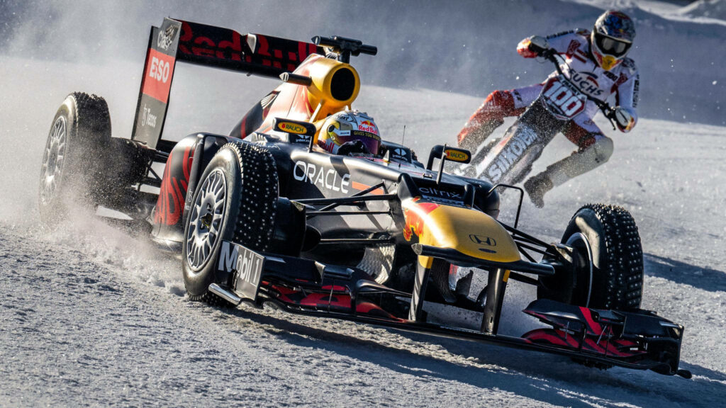 Max Verstappen drifts Red Bull Racing F1 car on snow with motocross rider Alpine Show Run wallpaper
