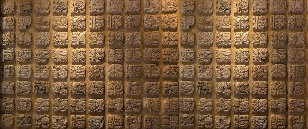 Symbolism in Stone: Ultra-Wide Mosaic of Maya Civilization on Ancient Stone Wall Background Wallpaper
