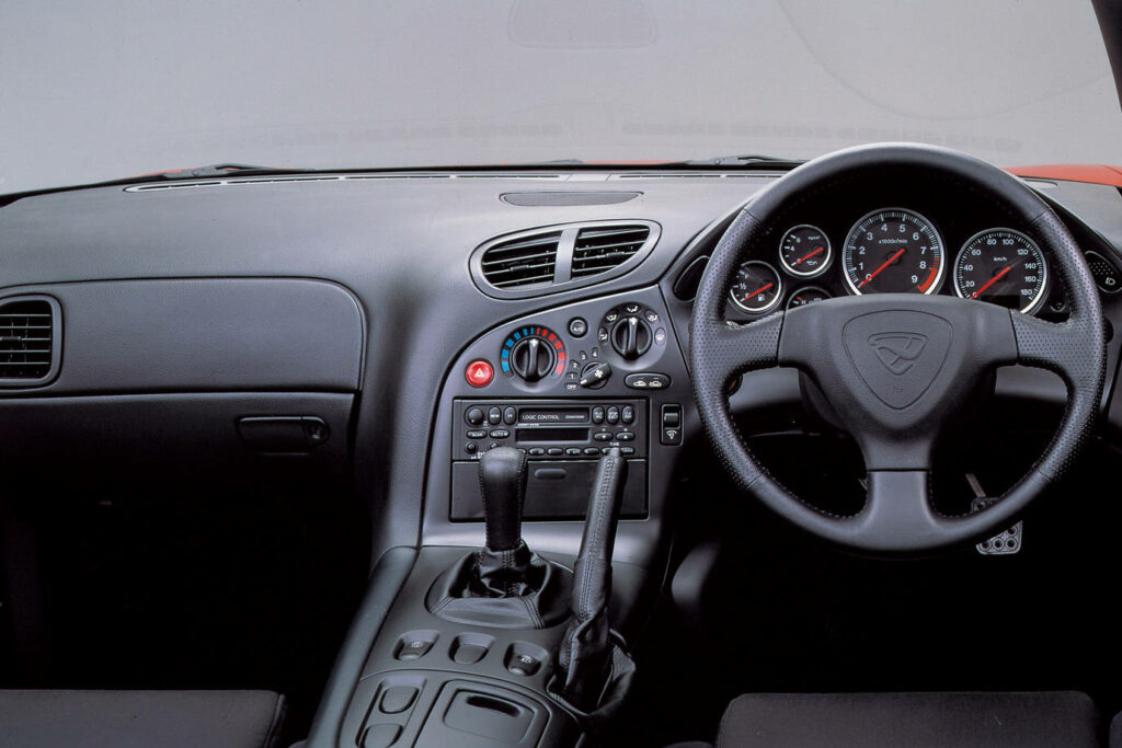 Immersive View of Rx-7 Interior: Right Driver's Seat, Left Passenger's Seat, Steering Wheel, and Dashboard on Display Wallpaper