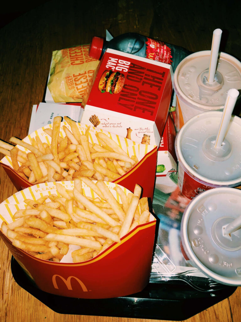 McDonald's Menu Delight: Big Mac, Fries & Drinks on Wallpaper Background