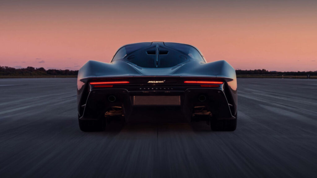 McLaren rear view 4K wallpaper sunset open road sleek futuristic design powerful supercar