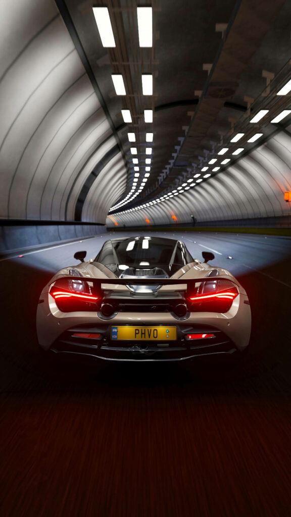 Rear view of McLaren 720S sports car in modern tunnel with sleek design and illuminated taillights Wallpaper
