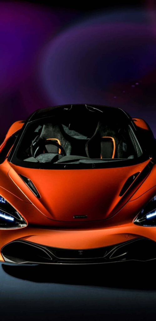 Front view of McLaren 720s in sleek orange with aggressive lines and neon-lit racing background Wallpaper