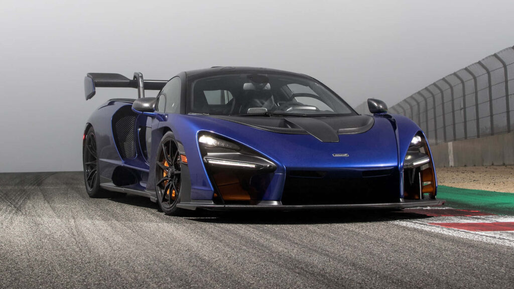 Blue McLaren P1 GT2 on racetrack with aerodynamic design rear wing and carbon fiber accents Wallpaper
