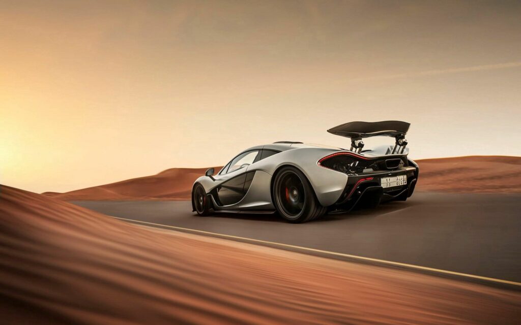 McLaren P1 Supercar Racing Through Desert Landscape Wallpaper
