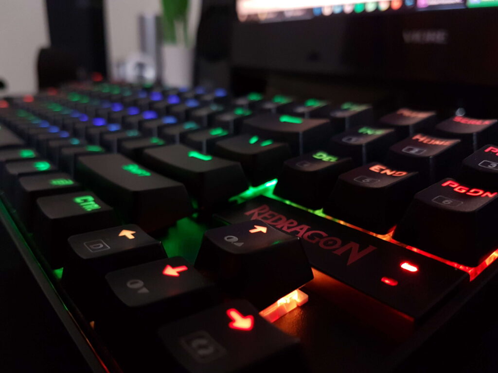 Close-up of Redragon mechanical gaming keyboard with vibrant RGB backlighting 4K wallpaper