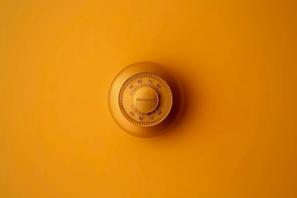 Mechanical Combination Lock on Vibrant Orange Wallpaper Background