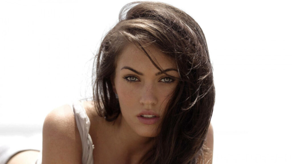 Megan Fox intense gaze brunette hair flowing bright minimal wallpaper background portrait