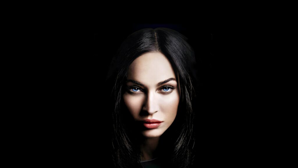 Striking portrait of Megan Fox on black background dramatic tablet wallpaper for fans