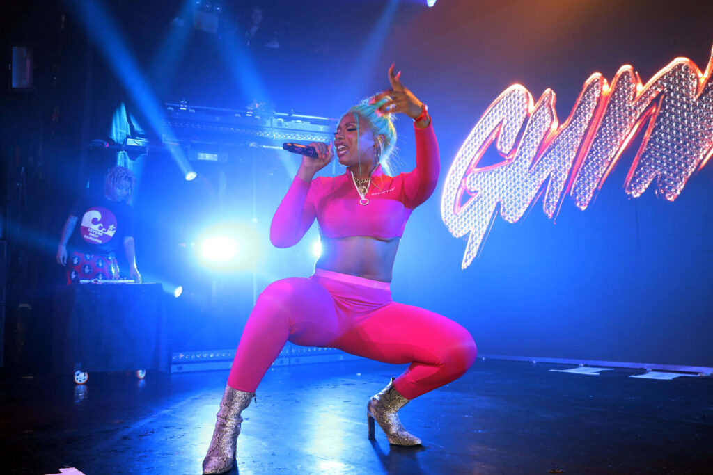 Megan Thee Stallion’s Energetic Stage Performance in Pink Outfit Wallpaper