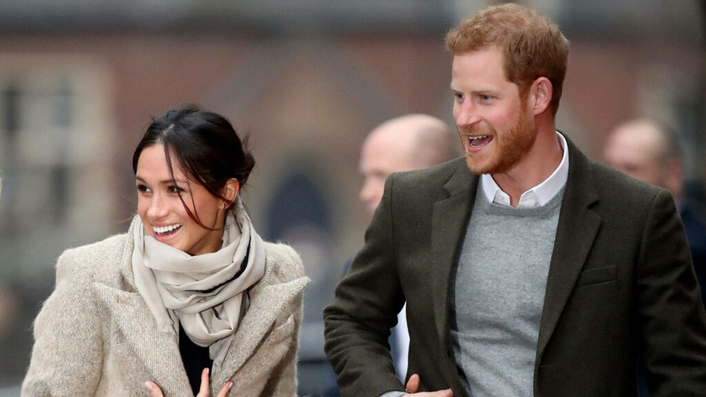 Meghan Markle and Prince Harry smiling and walking together happy dating wallpaper background