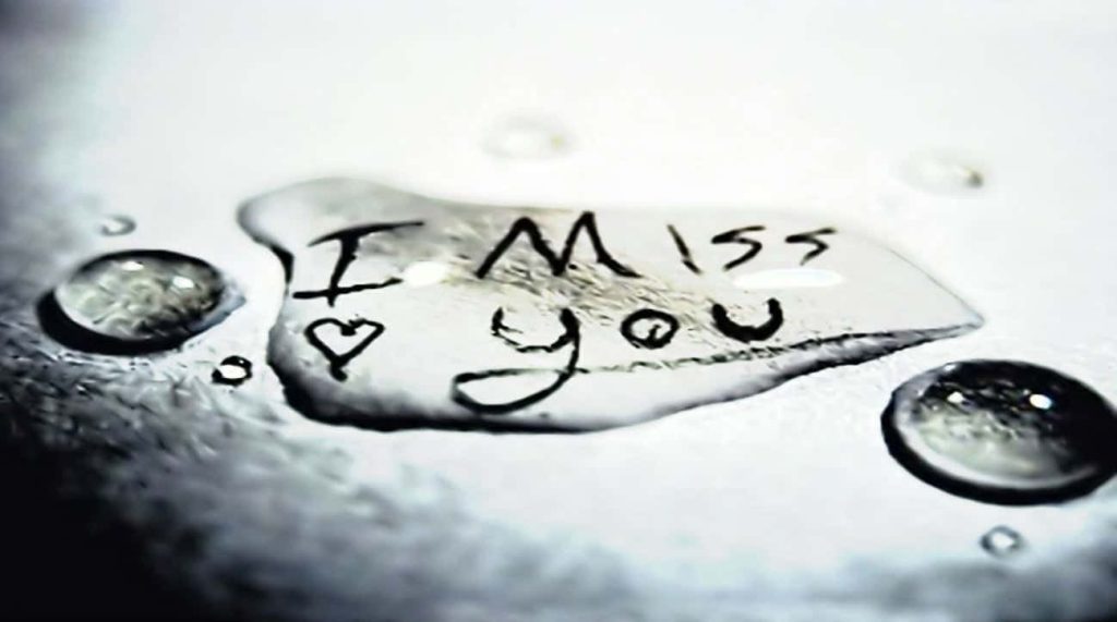 Melancholic I Miss You text with heart behind wet glass droplets grayscale emotional wallpaper