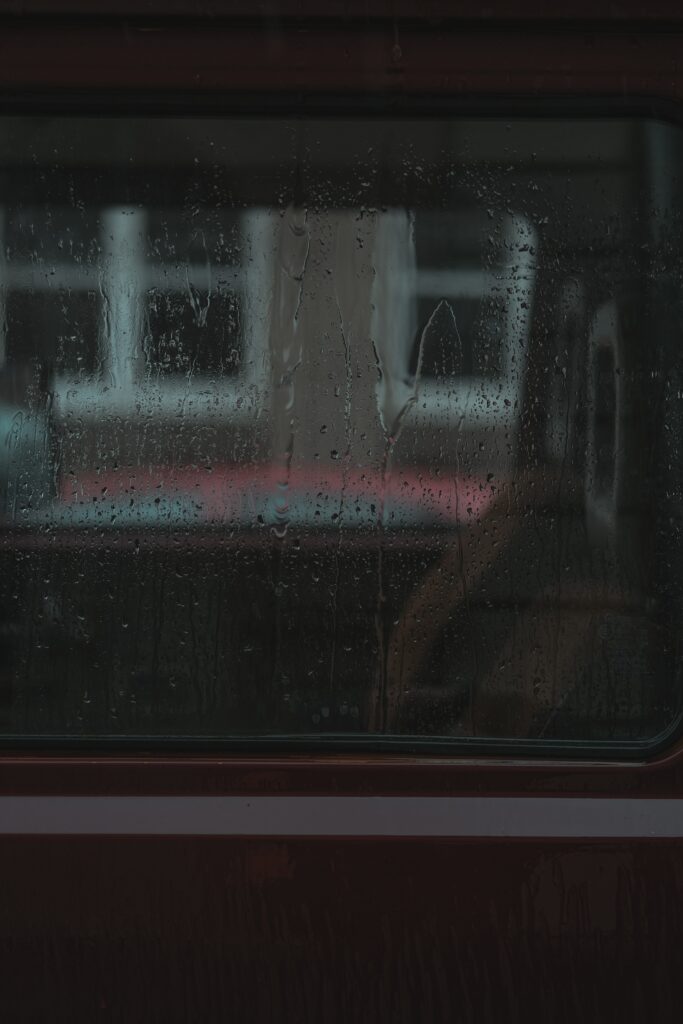 Melancholic Rainy Window: Vintage Car Interior & Architecture Wallpaper