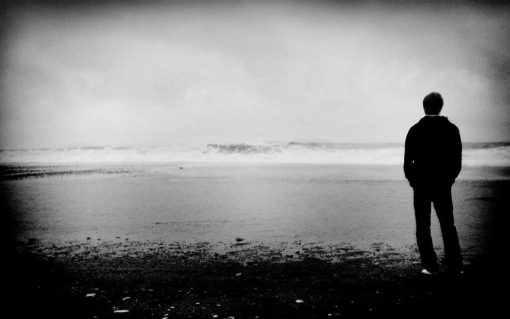 Lonely Figure by the Misty Lakeshore Wallpaper