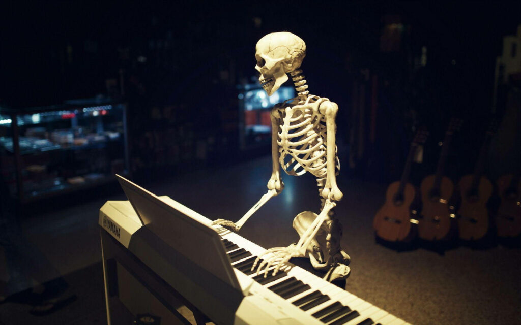The Ivory-Tapper in the Shadows: A Skeleton Pianist Desktop Wallpaper