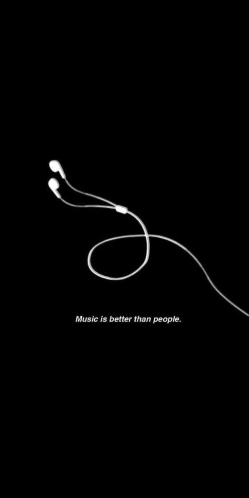 Melodious Isolation: Embracing the Black Aesthetic with Earphones and the Captivating Text 'Music Is Better Than People' Wallpaper