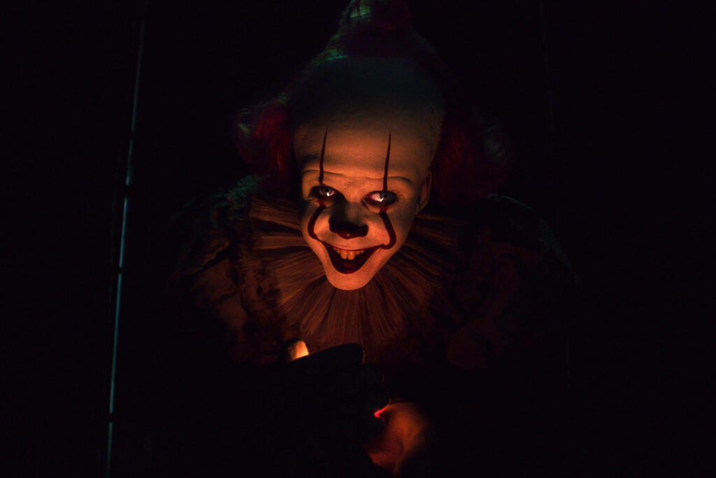 The Menacing Depths: Pennywise in a Deep Darkness Wallpaper